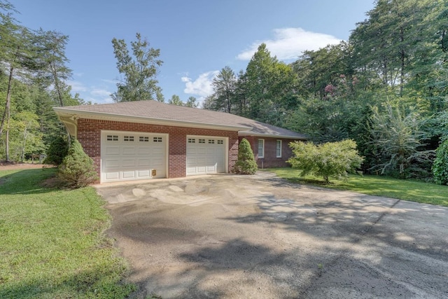 ranch-style home featuring a garage and a front lawn