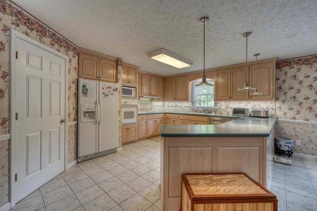 kitchen featuring white appliances, light brown cabinets, decorative light fixtures, light tile patterned floors, and a textured ceiling