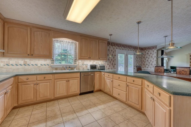 kitchen with dishwasher, pendant lighting, a wealth of natural light, and light tile patterned floors