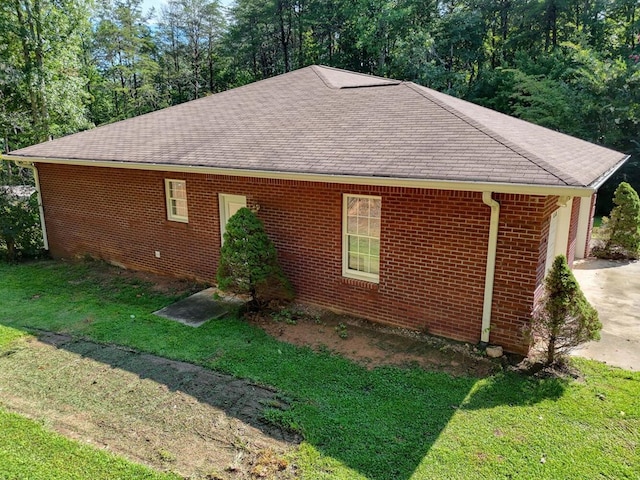 view of side of home with a yard