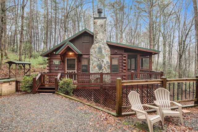 back of house with a wooden deck and a sunroom