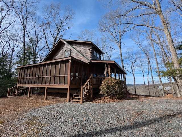 view of property exterior with a sunroom