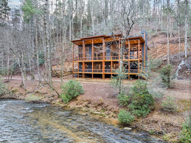 rear view of property featuring a water view