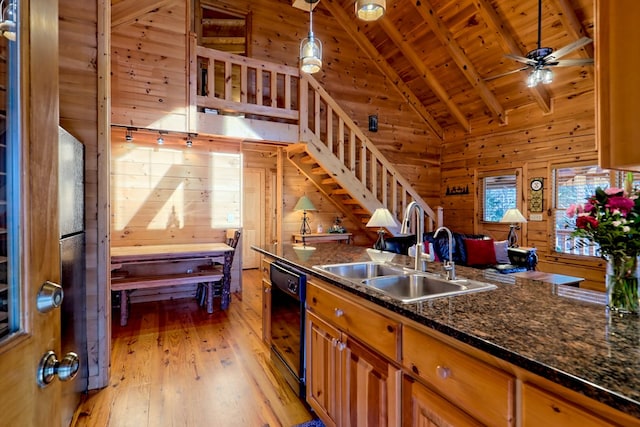 kitchen with wood walls, a sink, wood ceiling, dishwasher, and brown cabinetry