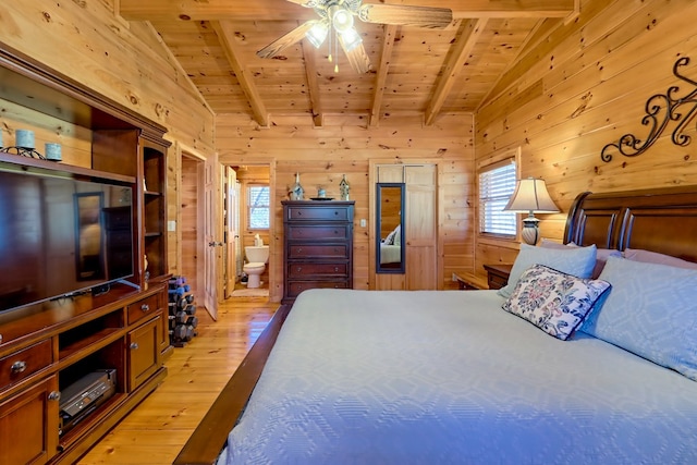 bedroom with wooden ceiling, wooden walls, and light wood-style floors