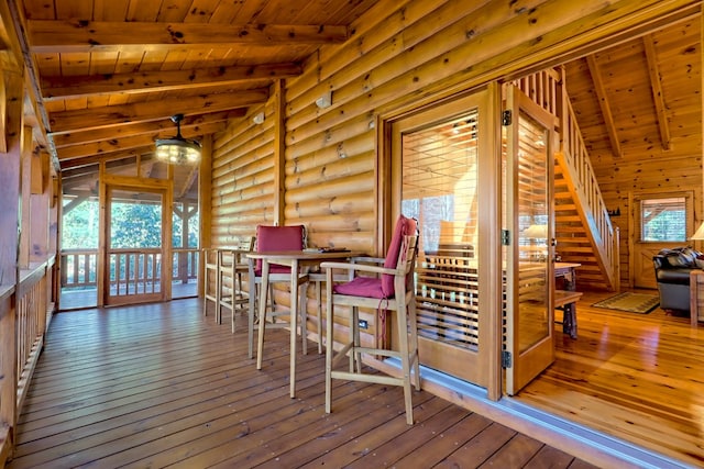 dining room with lofted ceiling with beams, wooden ceiling, and wood finished floors