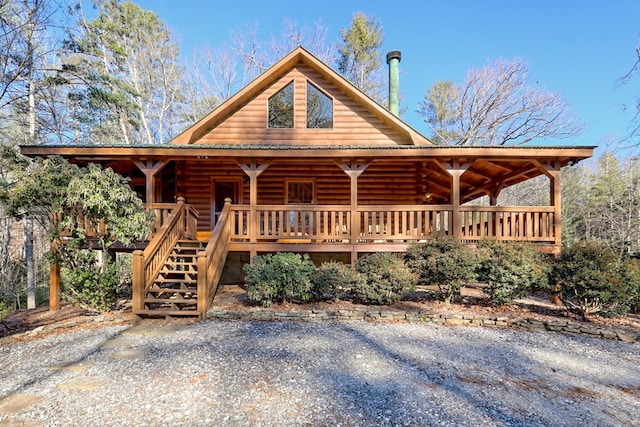 log-style house with stairway and log siding