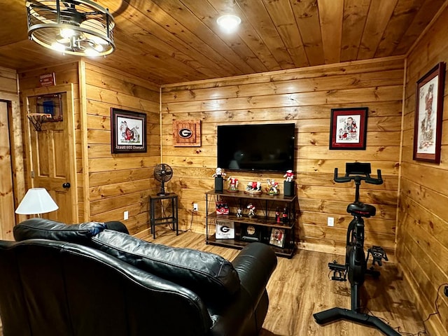 living room with wooden ceiling, wood walls, and wood finished floors