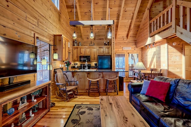 living area with wooden walls, wooden ceiling, beamed ceiling, light wood-style floors, and high vaulted ceiling