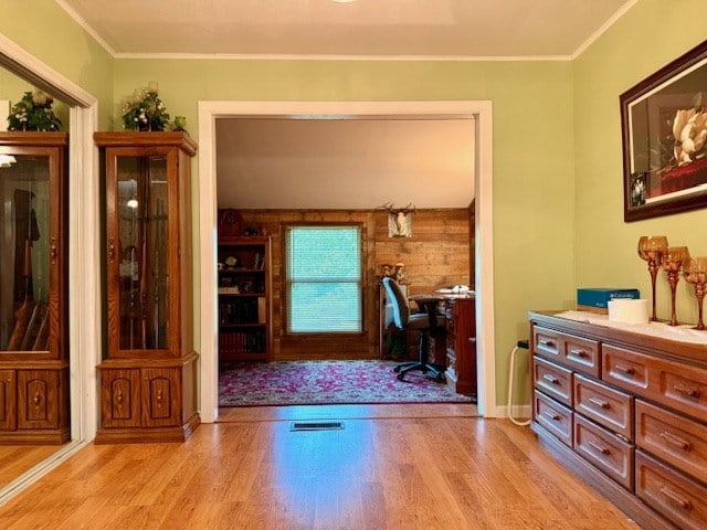 office area featuring light wood-style floors and ornamental molding