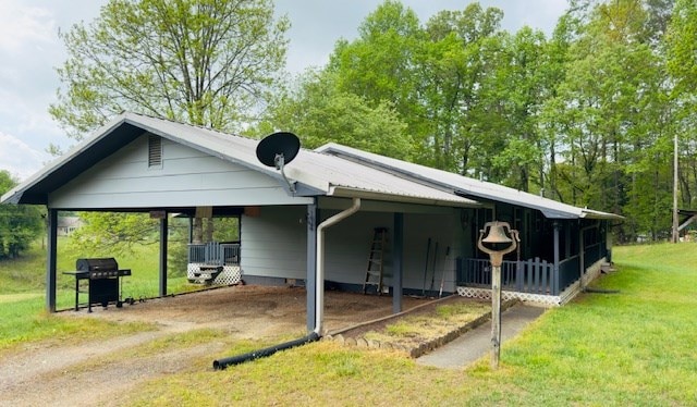 view of front of property with driveway, a front yard, and a carport