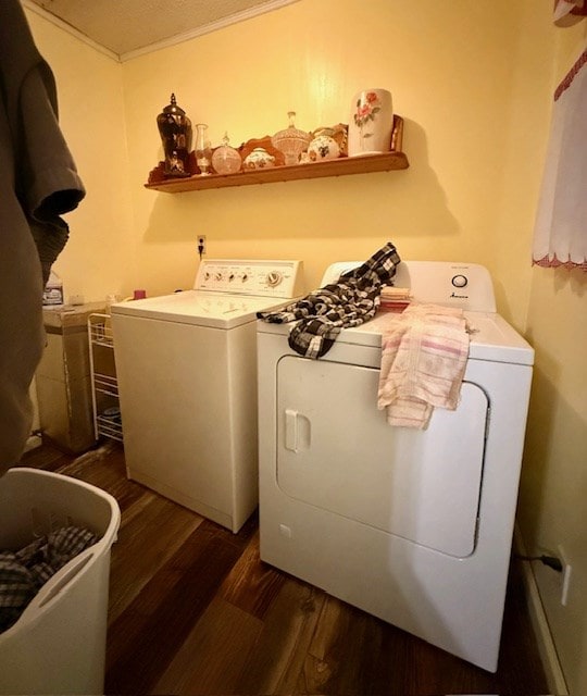 washroom with washing machine and clothes dryer, laundry area, and dark wood-style floors