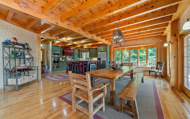 dining room with a notable chandelier, light hardwood / wood-style floors, wooden ceiling, and beamed ceiling