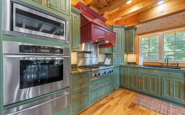 kitchen with sink, light wood-type flooring, stainless steel appliances, beam ceiling, and wooden ceiling