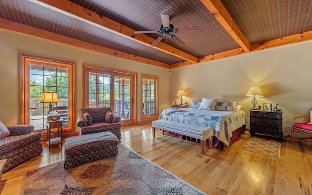 bedroom featuring ceiling fan, access to exterior, beamed ceiling, light wood-type flooring, and wood ceiling