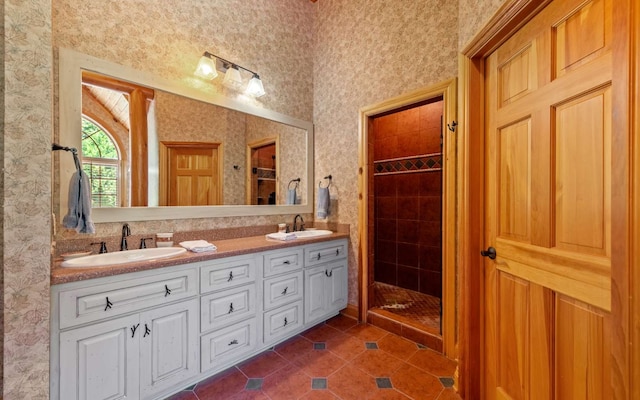 bathroom featuring dual vanity, tile flooring, and a tile shower