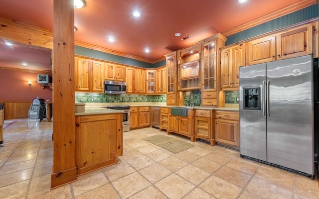 kitchen featuring light tile floors, ornamental molding, and stainless steel appliances