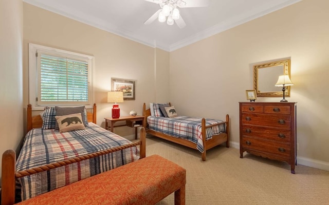 carpeted bedroom with ceiling fan and crown molding