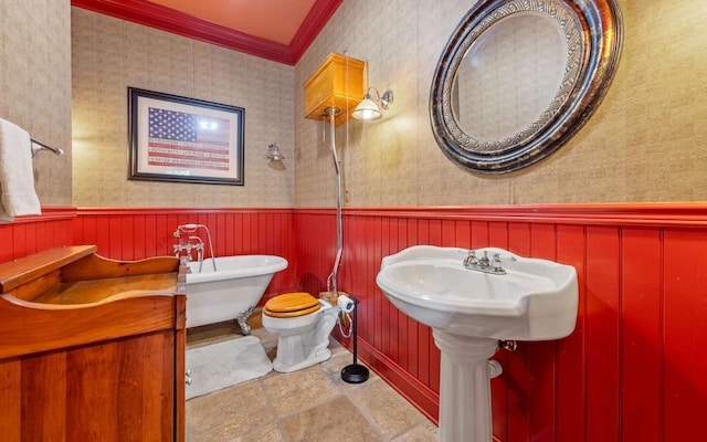 bathroom with toilet, ornamental molding, and tile floors