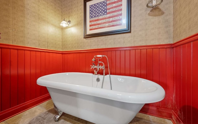 bathroom featuring a washtub and tile flooring