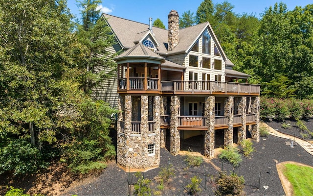 back of house featuring a balcony