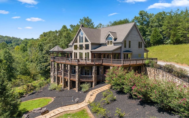 rear view of house featuring a wooden deck