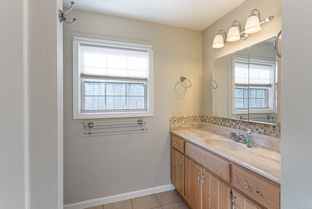 bathroom featuring vanity, tile patterned floors, and decorative backsplash