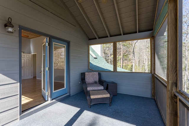 unfurnished sunroom featuring wood ceiling and vaulted ceiling with beams