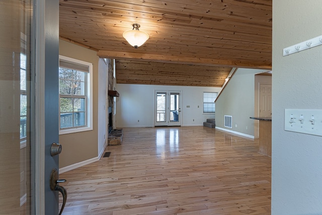 unfurnished living room featuring vaulted ceiling, light wood-type flooring, and wood ceiling