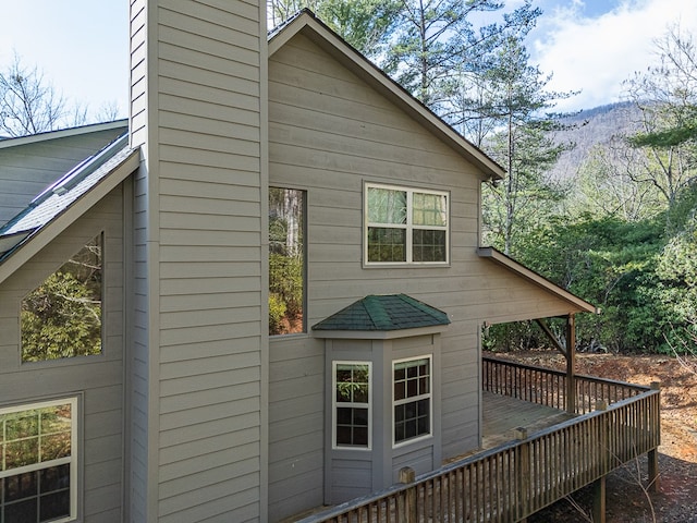 view of side of home featuring a wooden deck