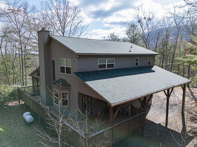 rear view of house featuring a wooden deck