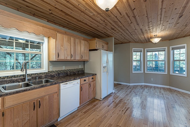 kitchen with plenty of natural light, sink, white appliances, and light hardwood / wood-style flooring