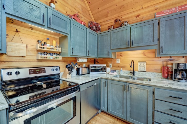 480 Sugar Mountain Rd, Blue Ridge, GA 30513 - kitchen featuring light stone counters, a sink, wooden walls, lofted ceiling, and stainless steel appliances