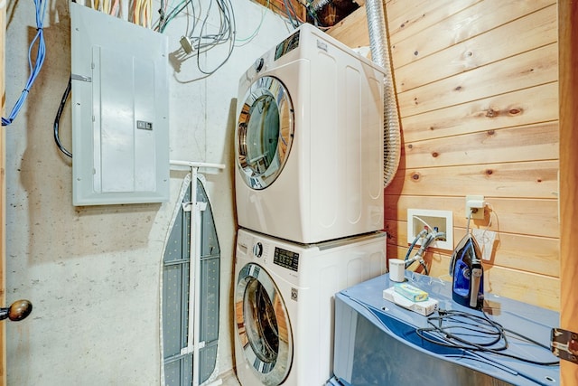 480 Sugar Mountain Rd, Blue Ridge, GA 30513 - laundry room featuring stacked washer and dryer, wooden walls, electric panel, and laundry area