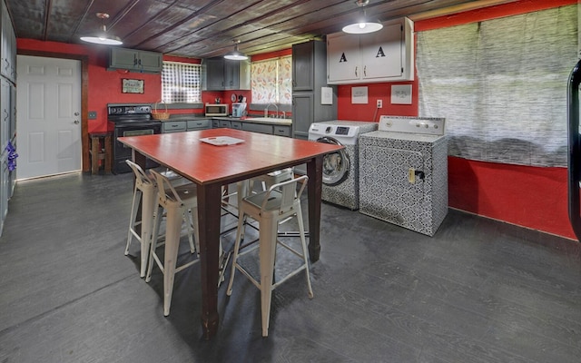 209 Vengeance Creek Rd, Marble, NC 28905 - kitchen with black electric range, stainless steel microwave, a sink, washing machine and dryer, and dark wood-type flooring