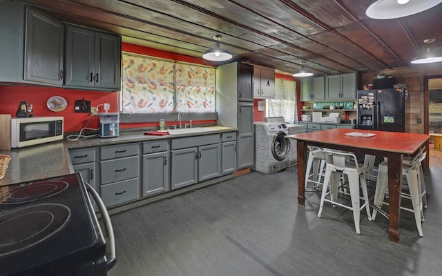 209 Vengeance Creek Rd, Marble, NC 28905 - kitchen featuring black fridge, washer / clothes dryer, white microwave, a sink, and electric stove