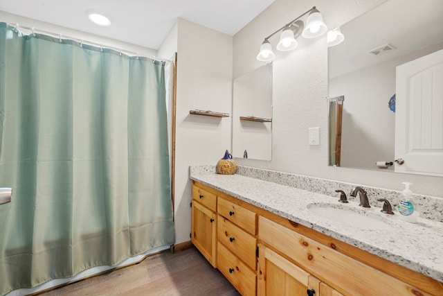 bathroom with vanity, hardwood / wood-style floors, and curtained shower