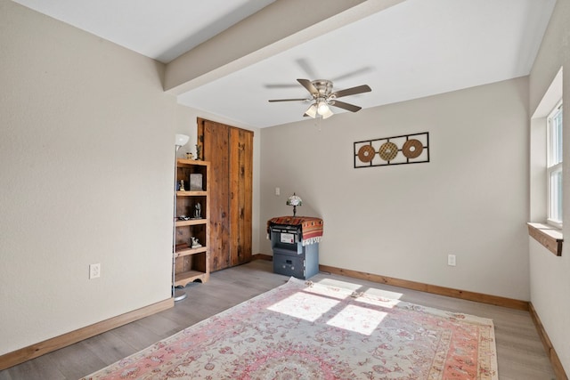 interior space with ceiling fan and light hardwood / wood-style floors