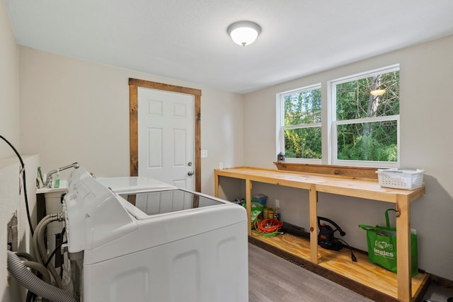 washroom with hardwood / wood-style floors and washing machine and dryer