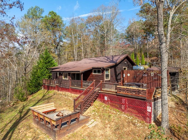 back of house with a lawn and a wooden deck