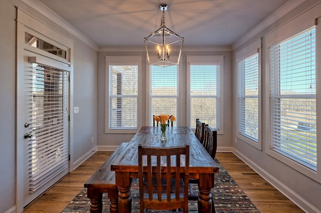 dining area with a notable chandelier, hardwood / wood-style flooring, and a wealth of natural light