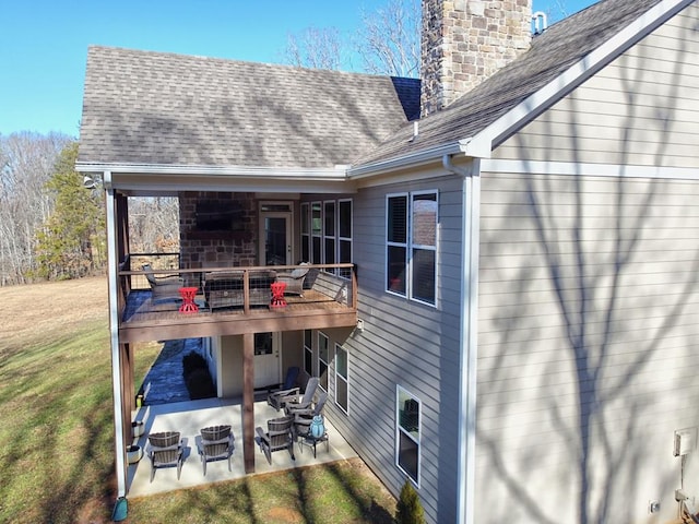 back of house featuring a lawn and a patio area