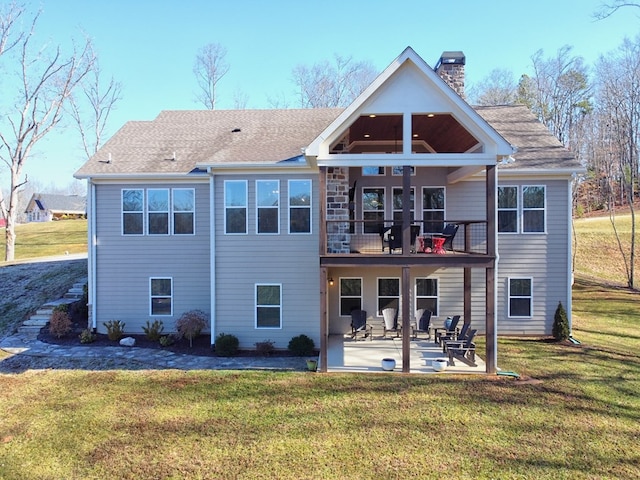 back of house featuring a balcony, a yard, and a patio area