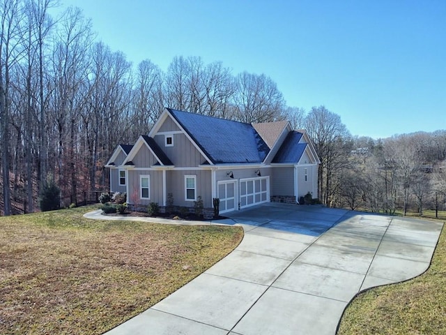 craftsman-style house featuring a garage and a front yard