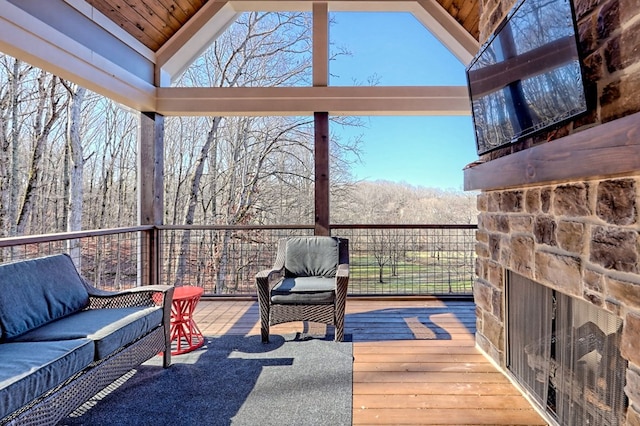 sunroom featuring vaulted ceiling