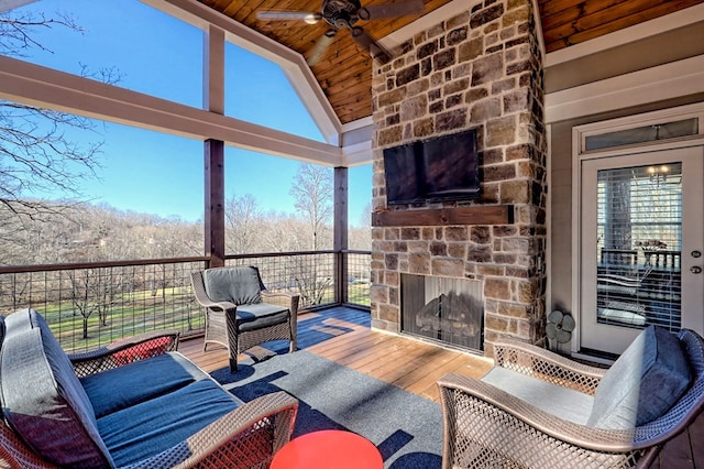 view of patio featuring ceiling fan and an outdoor stone fireplace