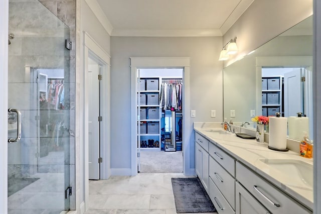 bathroom with vanity, crown molding, and walk in shower