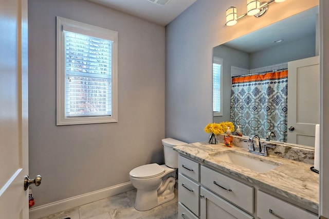 bathroom with vanity, toilet, and curtained shower