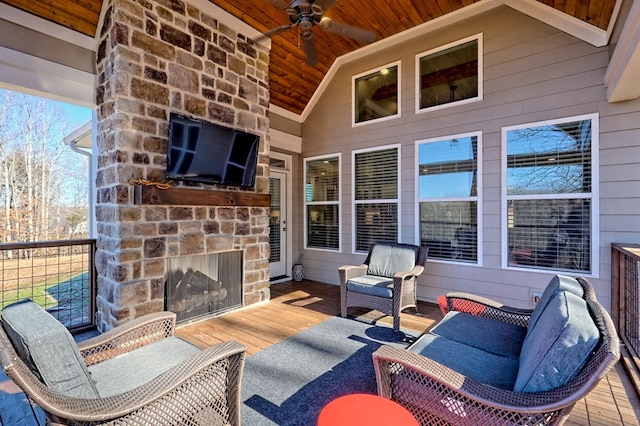 view of patio with ceiling fan and an outdoor stone fireplace