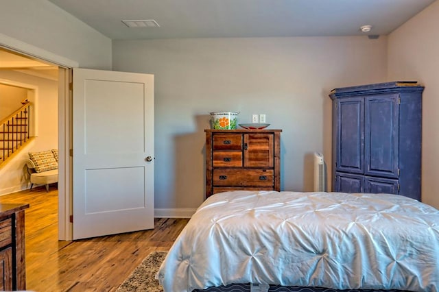 bedroom with hardwood / wood-style flooring